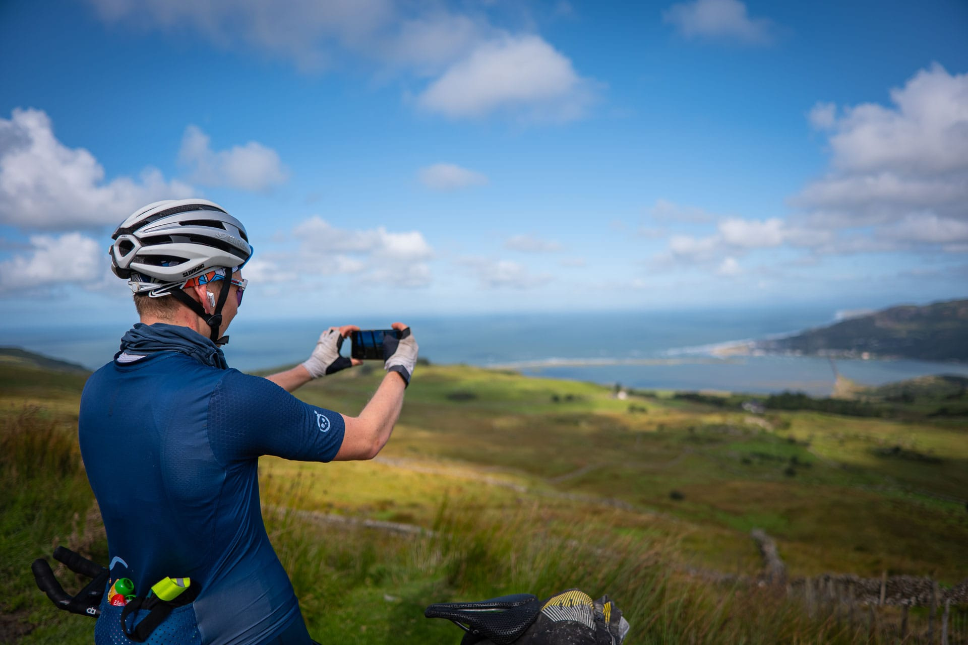 A rider photographing the view over the Mawddach estuary from Cregennan