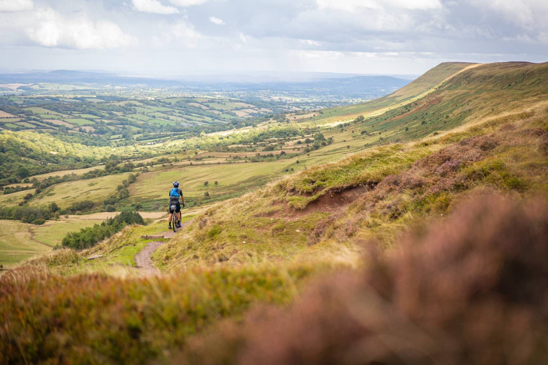 A rider climbing the grassy bridleway up Hay Bluff
