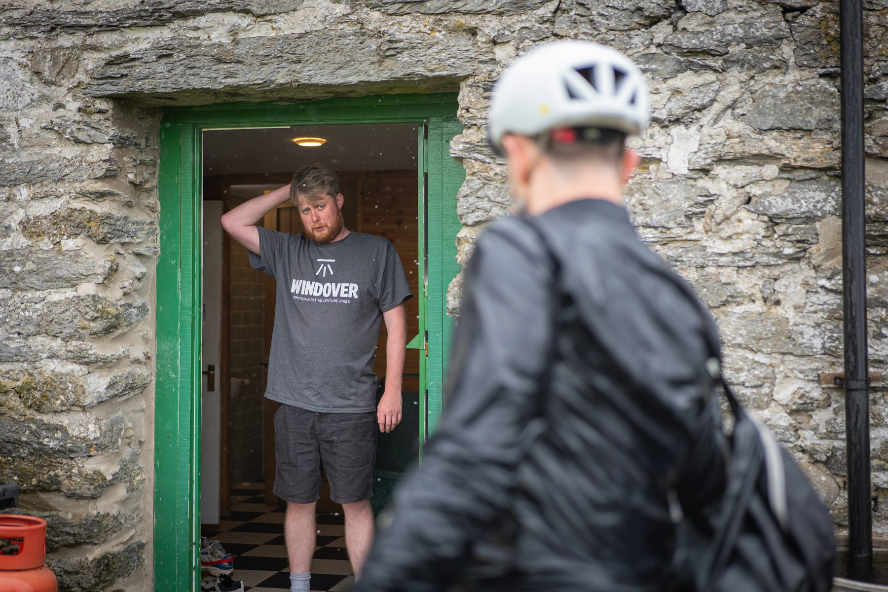 A rider standing in the stone doorway of the halfway checkpoint