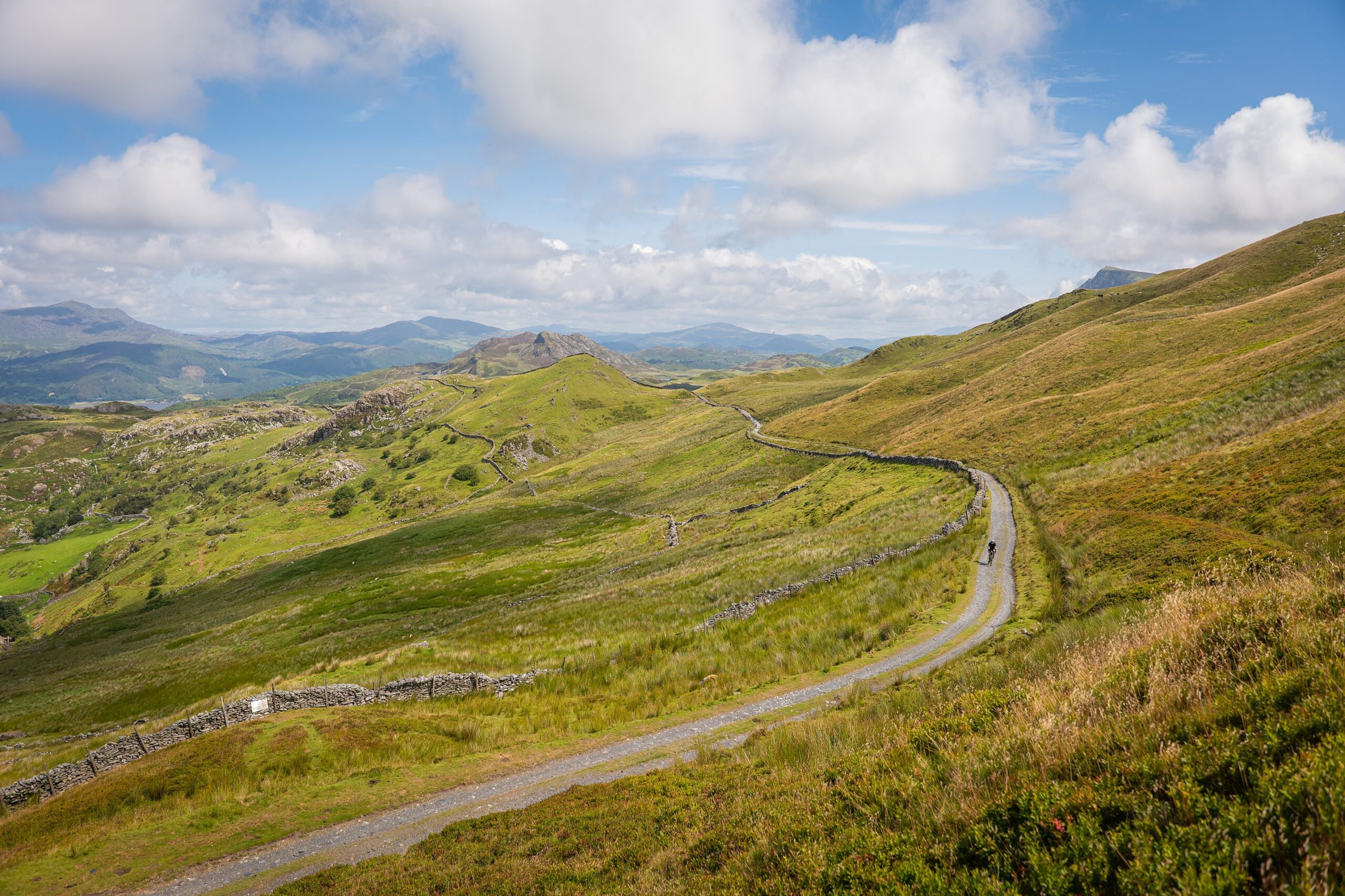 A single-track road winding through the Welsh hills