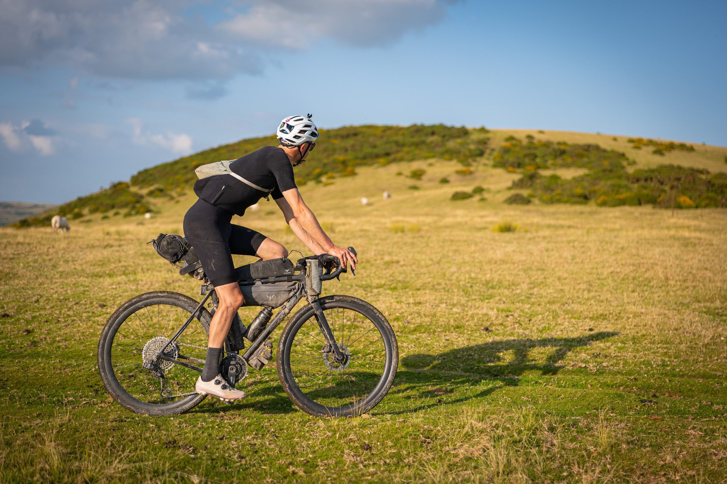A rider crossing golden grass above a green valley near Builth Wells