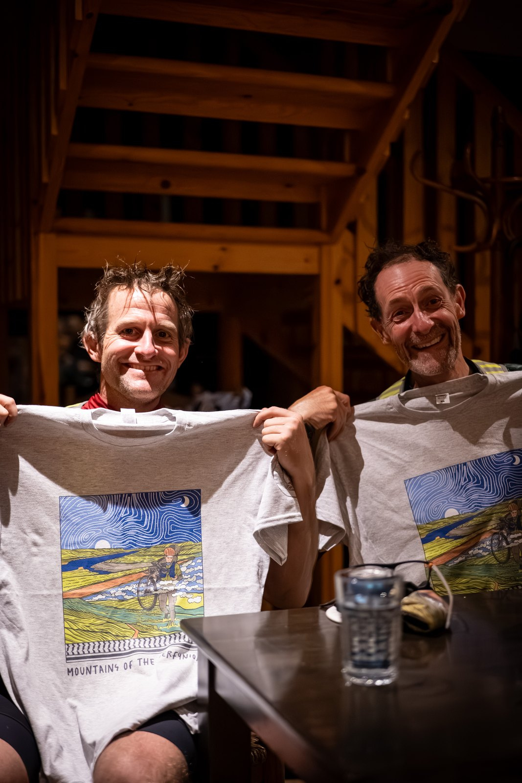 James Page and Jon Cox holding up their Mountains of the Merfynion finisher t-shirts